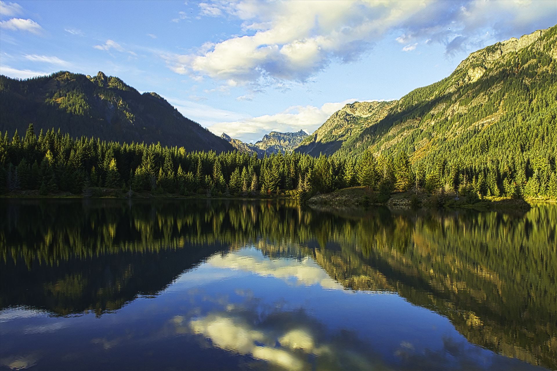 Reflection of Majesty - This is Gold Creek Pond near Snoqualmie Pass.  Taken just as the fall colors started to show on the mountainsides as the sun set behind me. by Bear Conceptions Photography